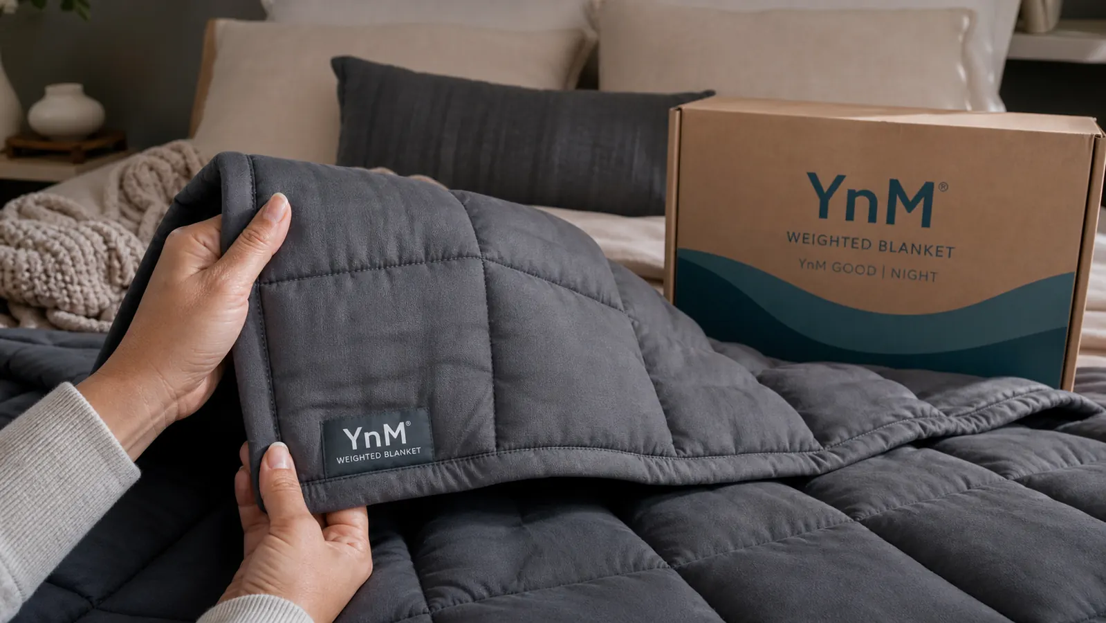 Close-up of YnM weighted blanket fabric showing the grid stitching and glass bead pockets